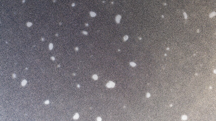 Closeup shot of the peat bog lake ice surface with the gas bubbles