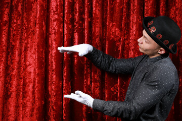 master ceremony on the stage in white gloves at red background