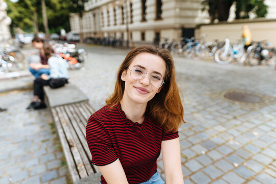 Cute relaxed young woman wearing spectacles