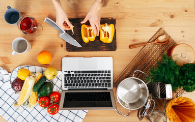 Unrecognizable woman cooking vegetables in her kitchen