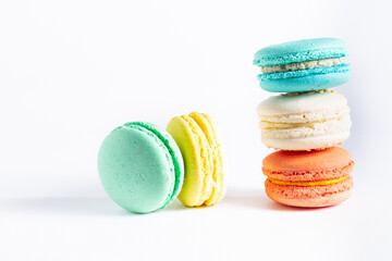 Colorful tasty macarons on white background. Traditional French dessert.