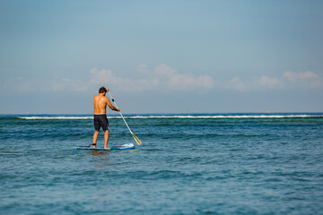 man riding sup