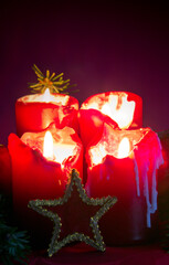Four red burning Advent candles and decoration. . Christmas background.