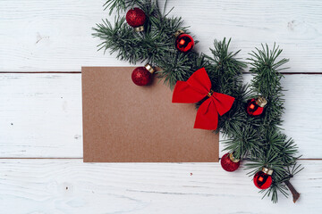 White wooden background with coniferous branches and Christmas decorations