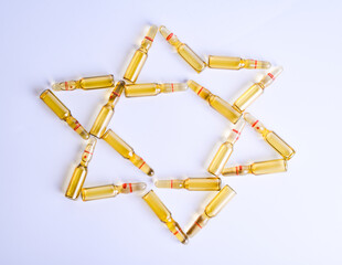 Star of David made from medical ampoules. The concept of vaccination. Coronavirus concept. Israel