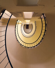 Yellow semicircle spiral staircase with black railings top view