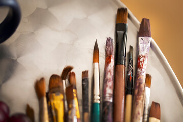 Close up of different paint brushes.