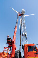 Worker operator of the aerial platform at the workplace. Installation of a wind generator. Russia,...