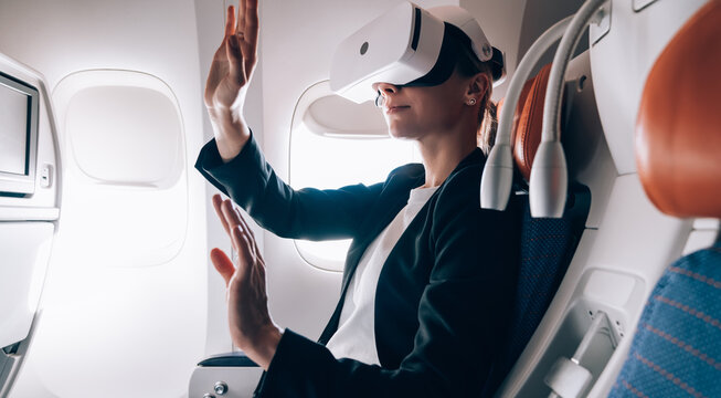 Female passenger in VR goggles in airplane