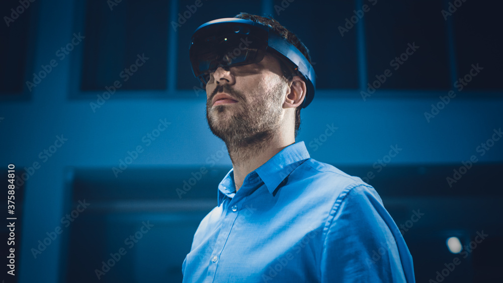 Poster In 3D Content Creating Laboratory Engineer Wearing Professional Virtual Reality Headset and Works in Augmented Reality. Stylish Low Angle Portrait Shot 
