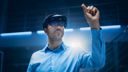 In 3D Content Creating Laboratory Engineer Wearing Professional Virtual Reality Headset Works and...
