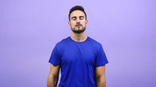 Young caucasian man tired and bored, doing a timeout gesture, needs to stop because of work stress, time concept