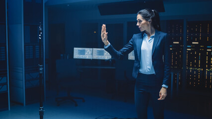 In Modern Data Center Research Laboratory Beautiful Confident Woman Does Virtual Reality Activating Touch Gesture. Mock-up Augmented Reality Shot.