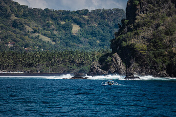 small boat floats on water with amazing mountain views