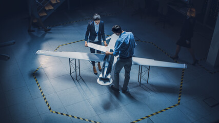 Team of Industrial Aerospace Engineers Work On Unmanned Aerial Vehicle Concept. Designers Work on...