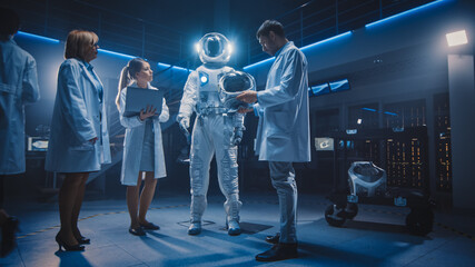 Team of Aerospace Scientists and Engineers Wearing White Coats have Discussion, Use Computers,...