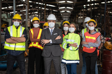 Group of industrial staff worker consist of Technicians, Engineers and factory Manager wearing...
