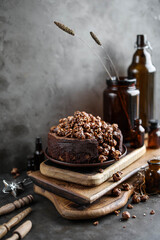 Very chocolate cake on wooden boards. Dark photography.
