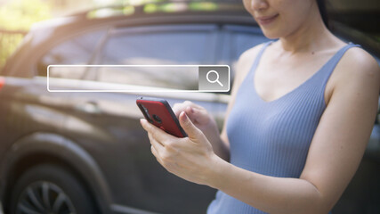 Hands using mobile phone or smartphone with with search box icon searching for information in...