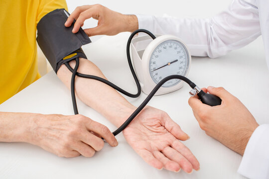 Doctor measuring arterial blood pressure of a patient, close-up