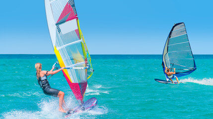 Beautiful cloudy sky with windsurfer surfing the wind on waves in Alacati - Cesme, Turkey 