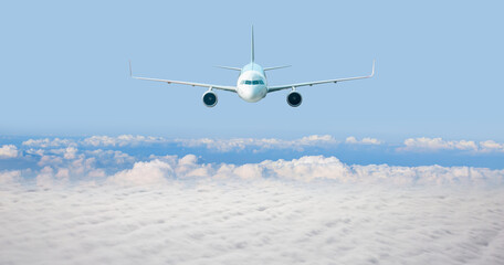 Fototapeta na wymiar White passenger airplane in the clouds - Travel by air transport