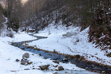 winter landscape with snow and a twisty stream of water