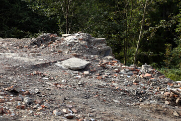 scattered building materials at the site of a demolished building