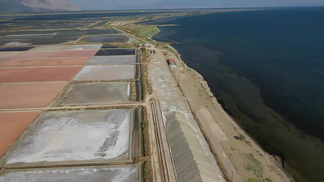Aerial drone video of colourful artificial sea salt ponds