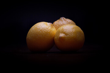 multiple Isolated yellow lemons, healthy food, on a black background
