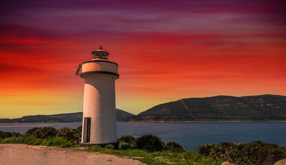 Lighthouse on the sardinian coast at sunset with dramatic red sky - Maristella, Sardinia