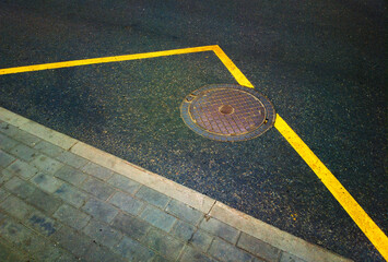 Manhole on road marking line Russian background