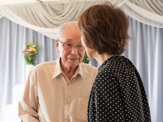 An old man talking to his adult daughter