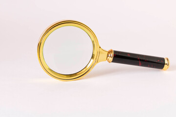 Old magnifying glass on a light background.