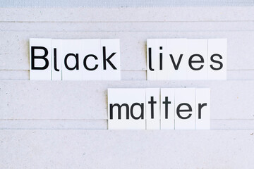 the word "Black lives matter" written on a board, antiracism massage for the world