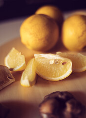 Lemons and Lemon slices on wooden plank