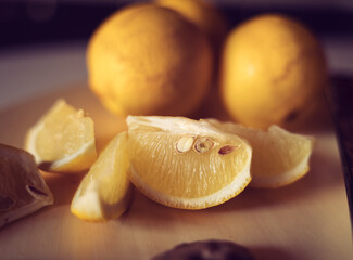 Lemons and Lemon slices on wooden plank