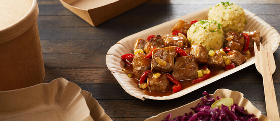 Takeaway serving of beef goulash and dumplings