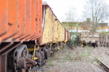 Selective focus shot of gondola cars from a freight train parked on a railroad © Véronique Van Der Wijst/Wirestock