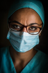 Young female medic, wearing a mask and glasses