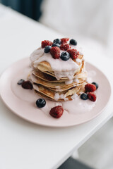 Stack of Small pancakes in syrup