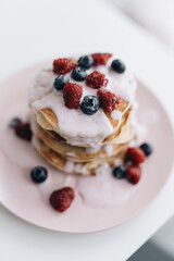 Stack of Small pancakes in syrup