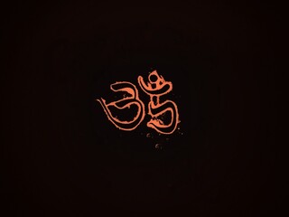 Saffron color Om text in dark background
