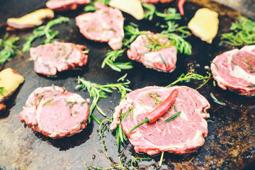meat pork with red chili pepper, rosemary cooking on pan