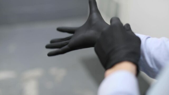putting on a latex glove