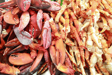 Close up view of many fresh crab legs and crab claw