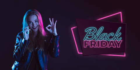 Online shopping. Portrait of young woman in neon on dark studio backgound. Human emotions, black friday, cyber monday, purchases, sales, finance concept. Copyspace. Seamless post for instagram.