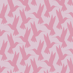 Fototapeta premium Seamless pattern with small flying birds of paradise hummingbirds on a pink background. Design for fabric, clothing, bedding, wrapping paper