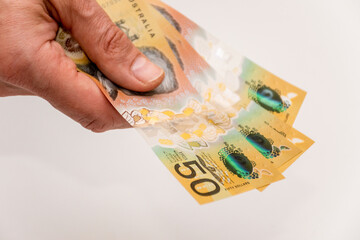 Hands holding australian dollars 50 banknotes. Finance and payment concept