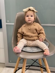 little girl sitting on a chair